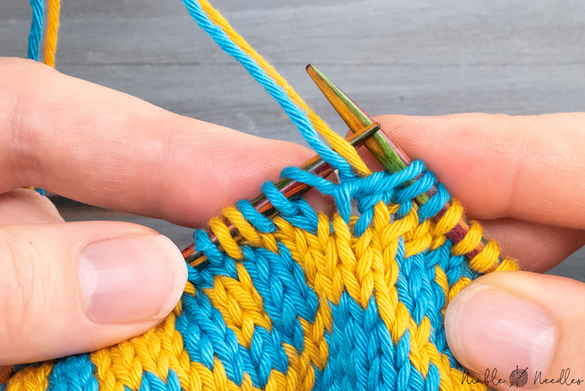 lifting the strand between the two stitches back to the knitting needle