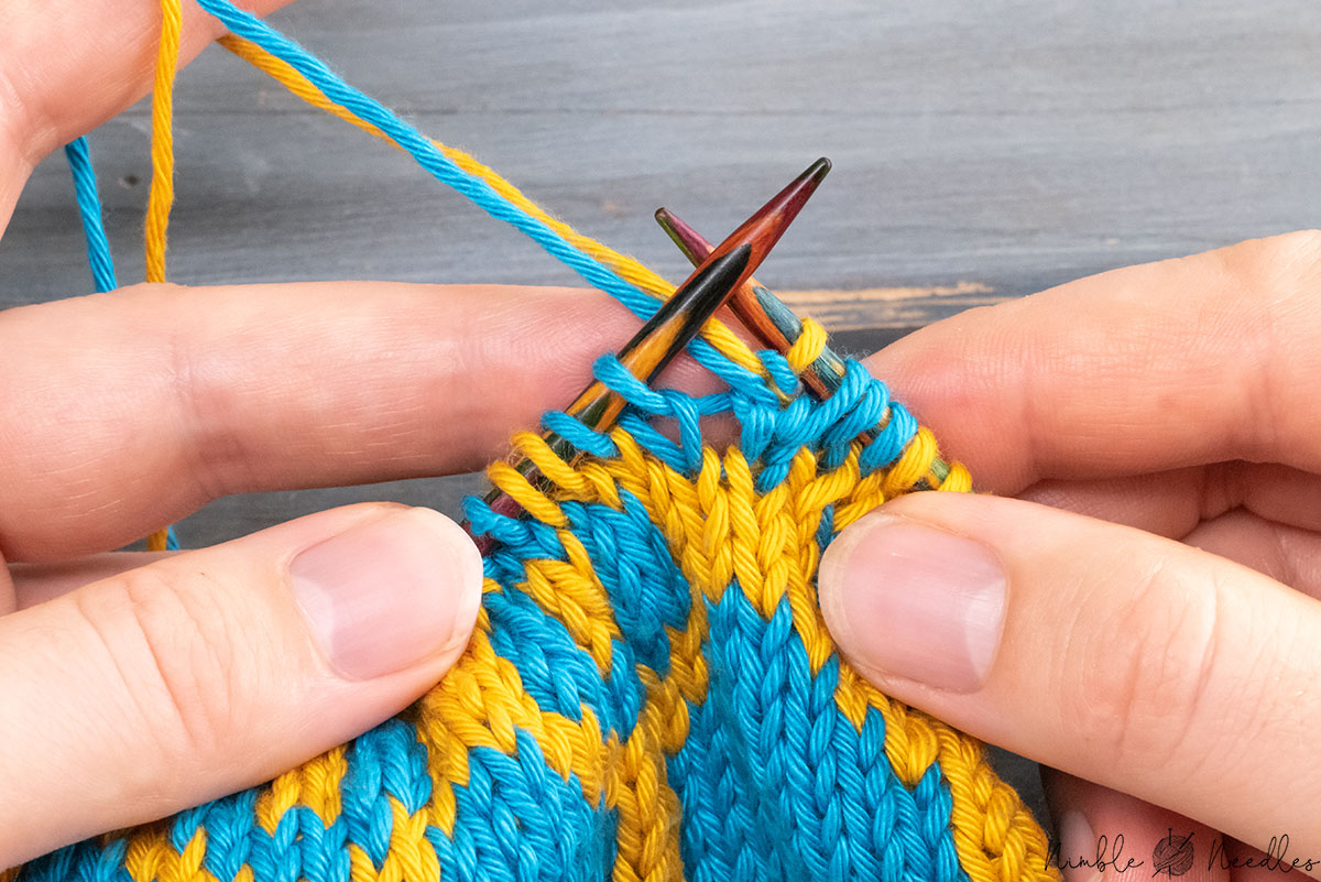 bringing both yarns to the back again