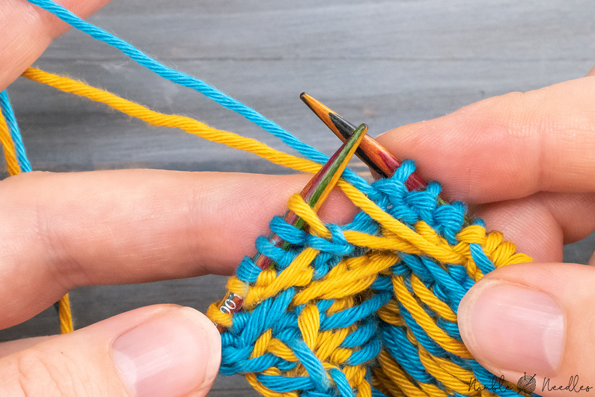 bringing both yarns to the back