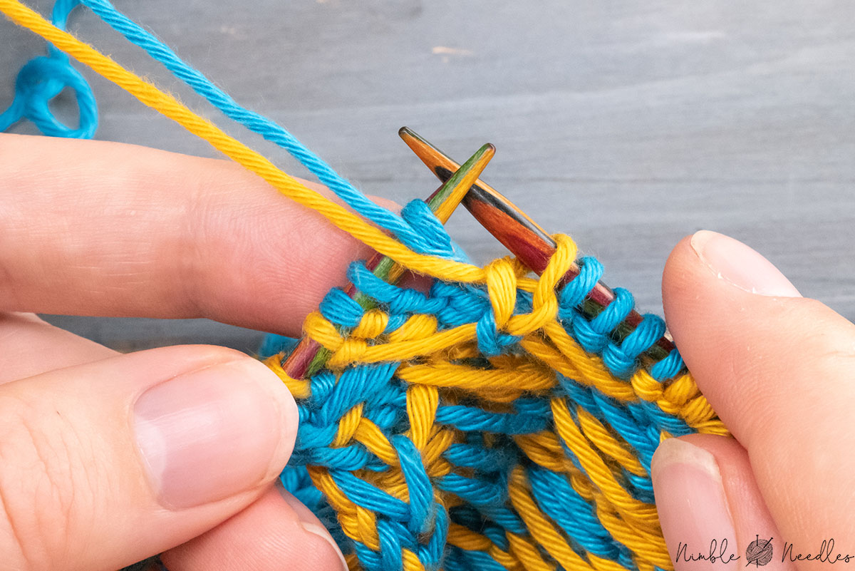 bringing both yarns to the front again