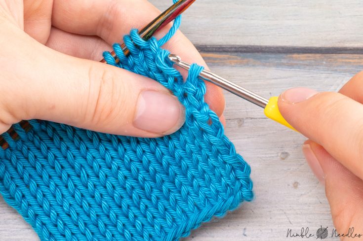 someone fixing a dropped stitch knitting