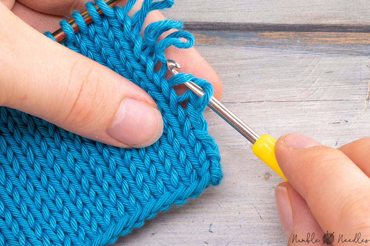 going underneath the upper loop with the crochet hook