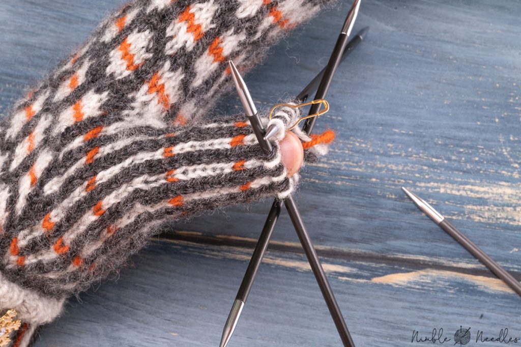 a picture showing when you have to start decreasing the thumb of mittens