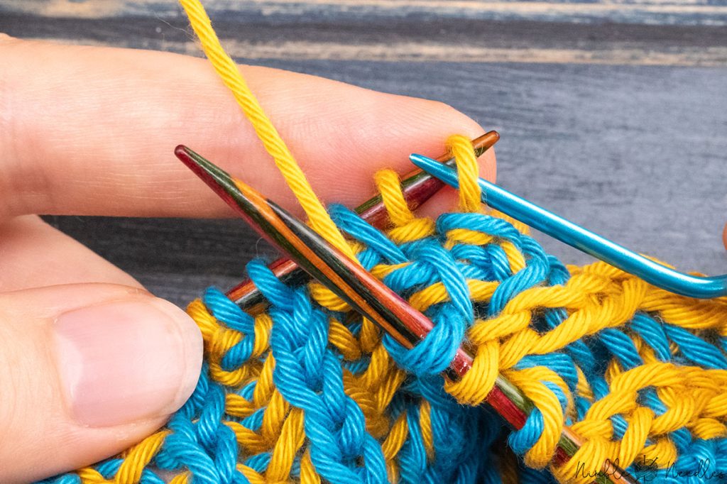 slipping back two stitches from the cable needle