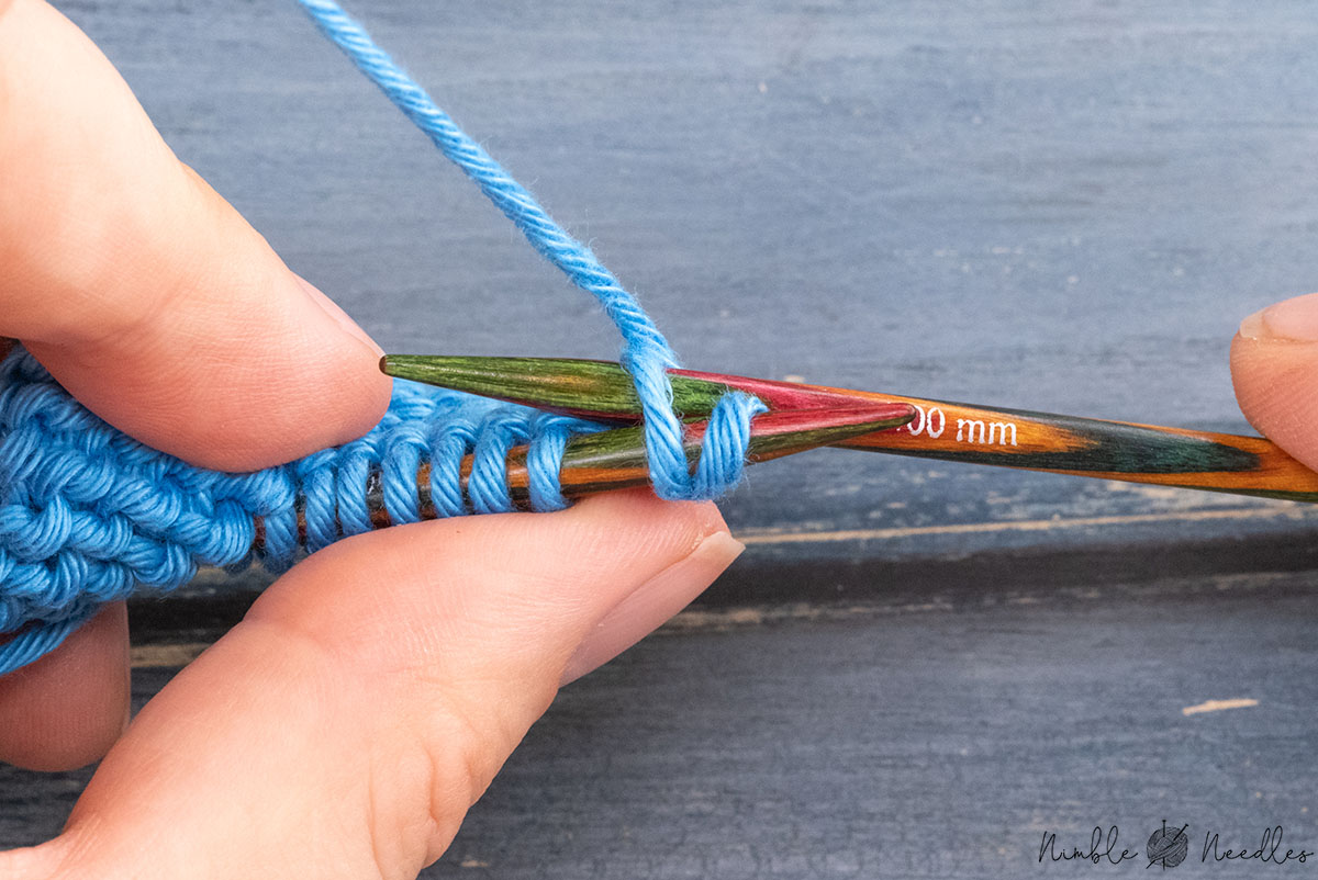 inserting the right needle into the second stitch on the left needle from behind