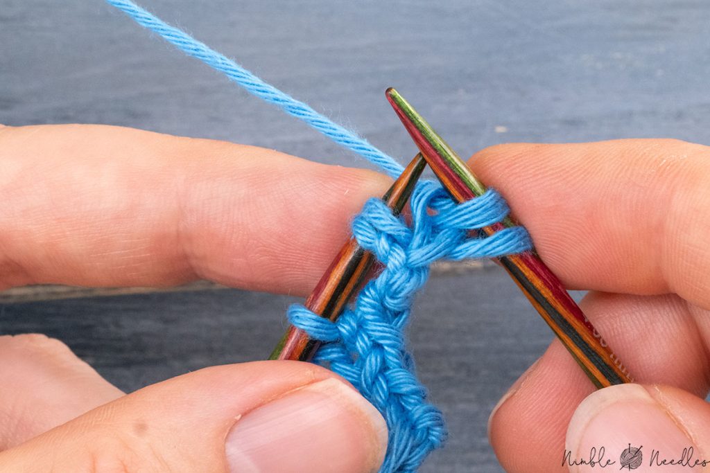 dropping the knitted loop off the left needle as normal